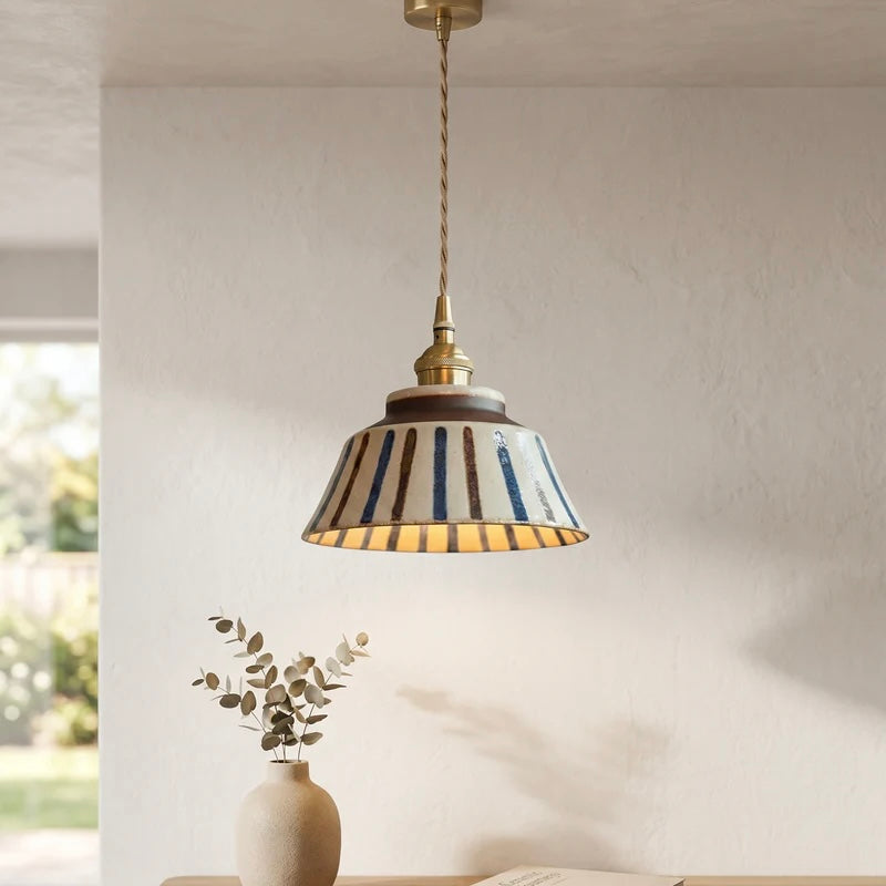 Textured Ceramic Pendant Light with Brass Details and Warm Lighting