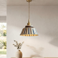 Textured Ceramic Pendant Light with Brass Details and Warm Lighting